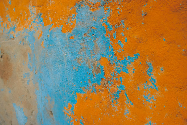 A textured wall painted with blue and then papaya orange. The wall emphasizes the story of the founders of Papaya Marketing, who discovered the brand idea while traveling Thailand.
