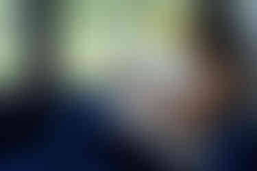 woman sitting at a window journaling