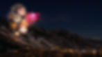 Image of fireworks being set off on a mountain, overlooking a city at night. 