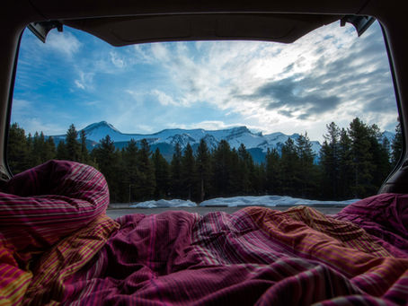 View outside rear Campervan doors looking at snowy mountains