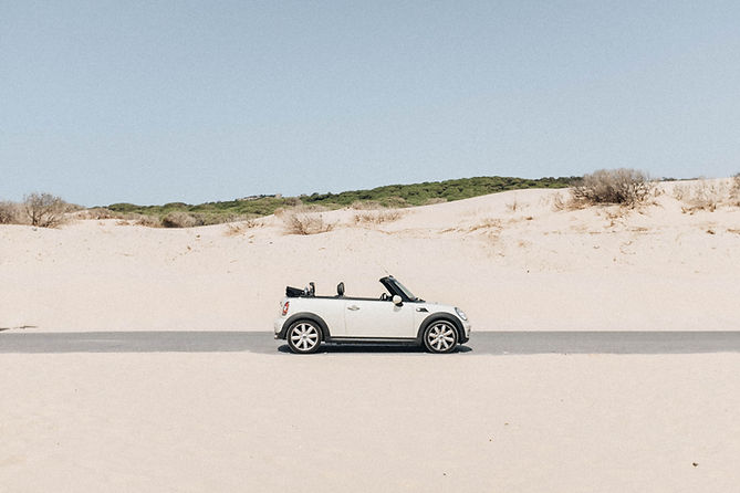 A mini car on the beach describing transportation options in the exclusive Algarve guide offered by the trusted realtor Lagos Homes in Portugal