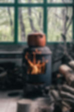 A clay pot over a fire. Cooking off grid outdoors.
