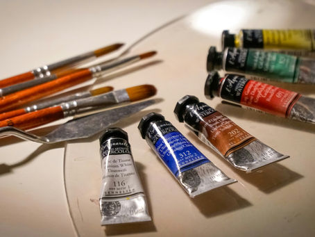 a display of paint brushes and paints for acrylic painting