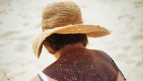 A woman wearing a sunhat in the beach
