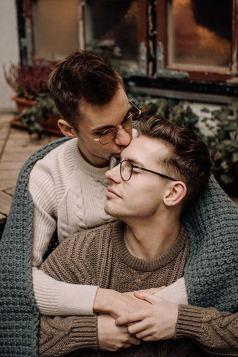 Man kissing his husband on the forehead | LGBT friendly couples counseling Denver | LGBTQ Relationship Counseling Denver | find relationship issues therapist in Denver | therapist for relationship issues Denver