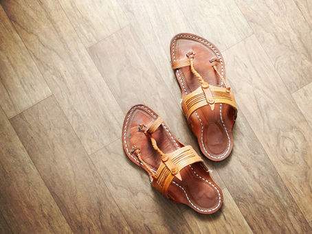 Kohlapuri sandals (chappals) on a hardwood floor