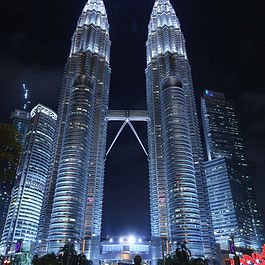 Iconic buildings - more than just bricks and mortar Iconic buildings do more than catch your eye. They help shape the future of cities by attracting investment, tourism, and community pride. From the Eiffel Tower to the Sydney Opera House, these famous landmarks are not just impressive structures—they are engines of economic opportunity. This article explores how iconic architecture can boost urban life, support local economies, and define city identity. We'll also take a closer look at why these buildings matter and how they impact the quality of life in the urban environments they are embedded within. 1. What makes a building iconic? An iconic building is instantly recognisable. It may be famous because of its design, cultural meaning, location, or the emotions it inspires. Unlike monuments, which honour people or events, iconic buildings are lived-in structures that contribute to daily city life. Their size, shape, and symbolism make them landmarks—and they often represent a city’s ambition, identity, or global status. From the Eiffel Tower in Paris to the Sydney Opera House, iconic buildings serve as cultural touchstones, defining the character and identity of a city. Tourists travel from all over the world to experience these structures, not just for their beauty, but for the stories they tell and the experiences they offer. As travel trends shift, new architectural landmarks are emerging as must-visit destinations, such as the Museum of the Future in Dubai, the Vessel in New York City, and Singapore’s Gardens by the Bay. These are not just monuments—they are interactive, immersive spaces that engage both locals and visitors. Take, for example, the Guggenheim Museum in Bilbao. Before it was built, the city was relatively unknown. After its opening, Bilbao saw a surge in tourism, investment, and cultural reputation. This phenomenon became known as the “Bilbao Effect”—proof that a single building can transform an entire urban landscape. 2. The economic ripple effect Iconic buildings can drive economic growth in several ways: Tourism: People travel from all over the world to see them. Tourists spend on hotels, restaurants, shops, and local attractions. Jobs and business: These buildings often lead to job creation in sectors like construction, maintenance, hospitality, and retail. Real estate value: Property prices often increase near iconic landmarks. Developers want to build around them, and companies want offices nearby to boost their brand. Urban regeneration: New buildings attract attention and funding for nearby infrastructure improvements. Economists studying the effects of iconic architecture often wrestle with how to define and measure their value. Some argue for a binary approach—iconic or not—while others suggest a continuum that could be developed through further empirical research. Spillover effects from such buildings often appear in the form of increased willingness-to-pay (WTP) for real estate that benefits from aesthetic proximity, as well as higher foot traffic supporting local businesses. Spillovers happen on multiple levels: Immediate surroundings : Like having a view from your window. District level : Prestige from living in a renowned neighbourhood. City-wide impact : Living in a globally recognised, modern city boosts the appeal of the entire urban area. For example, the Burj Khalifa in Dubai helped transform its district into a luxury commercial and residential zone. It brought with it new jobs, better roads, and high-end shops. 3. Urbanism and quality of life Urbanism looks at how people live in cities and interact with their surroundings. Iconic buildings play a big role here by improving quality of life. They become places where people gather, celebrate, and share experiences. They offer beauty, function, and meaning. Key urbanism principles linked to iconic buildings include: Open spaces that invite public interaction Buildings that reflect local identity and culture Places that encourage walking, social activities, and safety Design that supports sustainability and innovation These buildings aren't just for show—they become a meaningful part of daily life. The Bibliotheca Alexandrina in Egypt, for example, was designed to renew a city’s cultural spirit and serves as both a global library and a vibrant public space. The COVID-19 pandemic reshaped global travel, and architecture has adapted. Tourists now seek open-air, interactive, and nature-integrated spaces. Cities have responded with: Green urban spaces like rooftop gardens and walkable districts Touch-free technology such as Augmented Reality (AR) in museums Sustainable architecture that aligns with responsible tourism These shifts show how architecture is now expected to deliver experiences, not just aesthetics. 4. City branding and global image City branding is about shaping how a place is seen by outsiders. Iconic buildings are powerful tools for this. Cities like Paris, London, and New York have clear identities thanks in part to landmarks like the Eiffel Tower, Big Ben, and the Empire State Building. A city with a well-known landmark becomes easier to market. It’s seen as progressive, creative, or cultured. This image attracts tourists, businesses, students, and events. Even smaller cities can benefit. Reykjavik’s Harpa Concert Hall and Moldova’s Underground Wine City show how unique design can make lesser-known places stand out globally. In the digital-first world, iconic architecture doesn’t just exist in real life—it exists online. Social media platforms like Instagram, TikTok, and travel blogs drive architectural tourism by promoting photogenic, immersive landmarks. Examples include: The Louvre Abu Dhabi : Its floating dome has gone viral The Edge in Amsterdam : A sustainability icon that attracts global attention Apple Park in California : Corporate, but strikingly designed and widely shared A strong image also feeds back into quality of life. When locals are proud of their city, they engage more in their communities. Investment in branding, events, and local culture tends to follow. 5. Tourism and cultural impact Iconic architecture draws different types of tourists: Culture seekers who want to visit historic or meaningful places Design lovers who appreciate innovation and form Event visitors attending festivals, concerts, or conferences Well-designed buildings can also support: New businesses like cafés, art galleries, and boutique hotels Overnight stays due to increased interest Cultural activities like art shows, public lectures, and markets The Gateway of India in Mumbai not only draws tourists but has hosted major global fashion shows like Dior’s Pre-Fall event—blending local heritage with international appeal. 6. Impact on community and the built environment A good city serves its people—and iconic buildings can help achieve that. They give residents shared spaces, raise local pride, and encourage interaction. When well-integrated, they: Reflect the community’s needs and identity Create jobs and support local economies Raise land values, which can support infrastructure upgrades Cities and developers benefit from these buildings. They attract educated residents and funding, and they allow project developers to seek subsidies or approvals more easily. However, challenges must be managed: Too much tourist traffic can stress old buildings and public spaces Rising property values may push out long-time residents Maintaining iconic buildings can be costly and complex Good planning includes public input and long-term vision. Urban projects must prioritise accessibility, inclusiveness, and sustainability. 7. Case study: Bibliotheca Alexandrina, Egypt Located on the Mediterranean coast of Alexandria, this library is a modern reimagining of the ancient Library of Alexandria. Designed by Norwegian firm Snøhetta, the circular structure is carved into the earth and tilted toward the sea. It features inscriptions from 120 global alphabets and houses millions of books, exhibition spaces, and a planetarium. Its impact includes: City branding : Alexandria is now internationally known for this structure Tourism : It has become a major attraction in Egypt Education and culture : It is a hub for learning and creativity Urban renewal : Nearby roads and facilities were upgraded It shows how iconic design can link history, culture, and innovation while driving development. 8. Measuring the impact: a framework Researchers suggest a simple way to assess the value of iconic buildings: Physical identity : Does the building stand out visually and symbolically? Marketing tool : Does it boost the city’s image and attract attention? User experience : Does it serve residents and visitors well, offering quality interaction? When all three factors are strong, the building becomes more than an asset—it becomes a catalyst for wider growth. Future research on this topic could include deeper assessment of the characteristics of 'successful urban environments' with iconic buildings. It could also include further research into the tangible public benefits derived and how these can be maximized for the surrounding areas. Iconic buildings - symbolic and economic benefits for urban environments Iconic buildings aren’t just symbols; they are engines of progress. When thoughtfully designed and managed, they boost local economies, attract global attention, and enrich daily life. From Moldova to Mumbai, and Alexandria to Bilbao, the evidence is clear: great architecture can lift cities and communities. These structures enhance human capital by drawing educated residents, boost investor confidence through increased visibility, and become anchors of city pride. The synergy between architectural splendour and economic vitality is undeniable. As cities grow and compete for talent, investment, and recognition, iconic architecture offers a strategic advantage. By combining beauty, function, culture, and identity, these structures can define places—and create lasting economic opportunities. The future lies in buildings that are green, smart, and socially inclusive. Architects and city planners should embrace innovation while ensuring that their designs resonate with communities and promote sustainable urban living. Want more insights? Subscribe to GJC articles See more here: https://www.georgejamesconsulting.com/