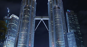 The Petronas Twin Towers and their skybridge lit up at night, Kuala Lumpur