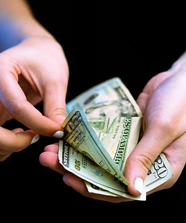 Picture of theft where a person is stealing or skimming cash or money.