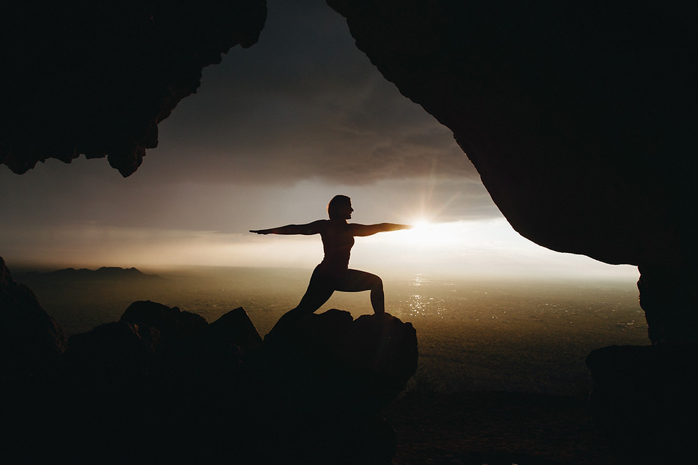 woman practicing yoga poses in the sunset in the grand canyon