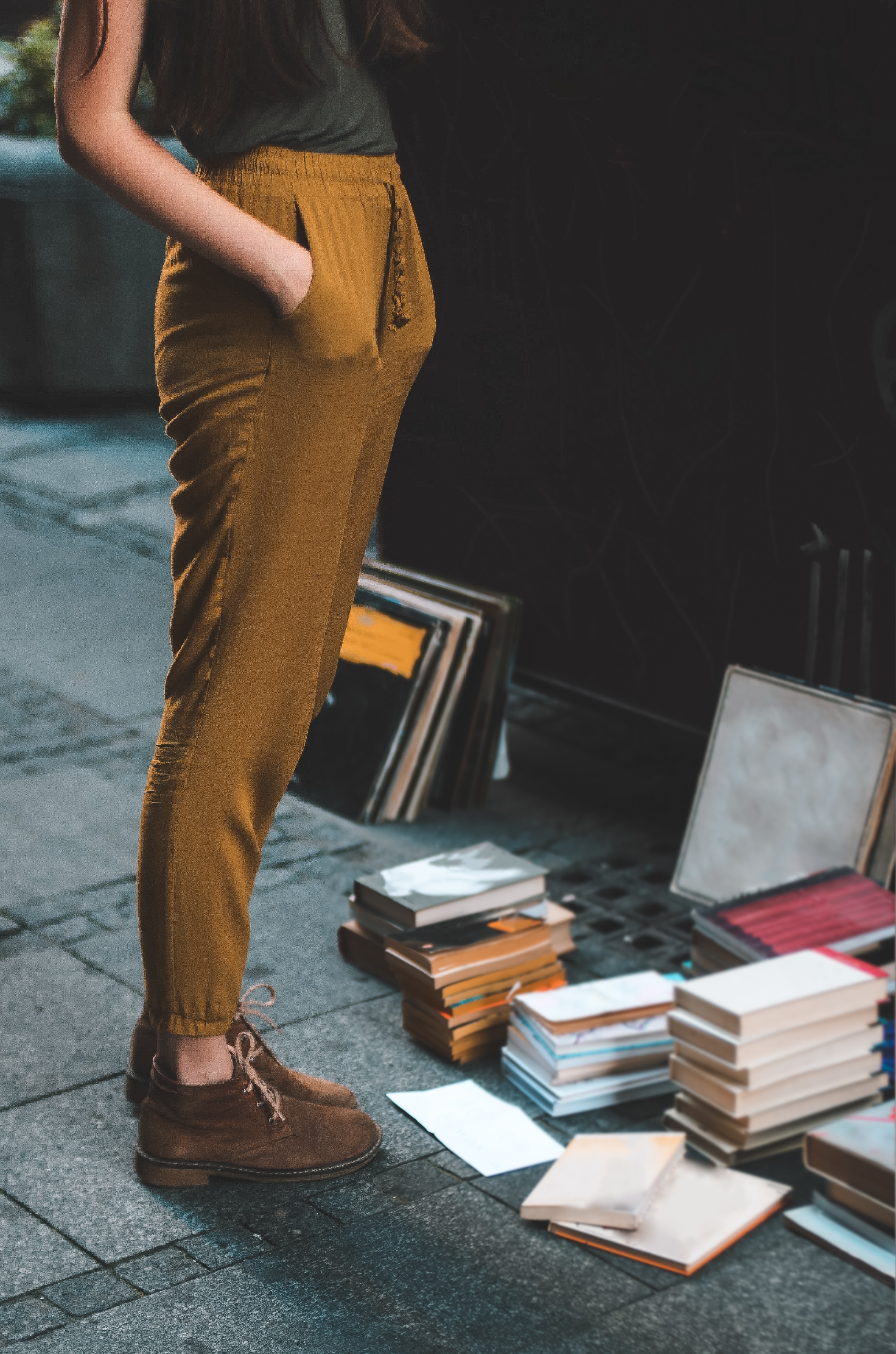 Woman looking at books for sale on the street