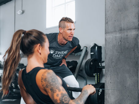 Personal trainer helping client stay healthy during the holidays at SRQ Health & Fitness Studio in Sarasota.