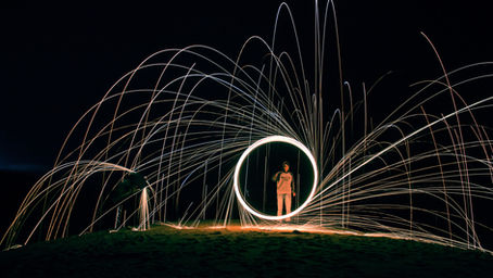 A person standing in a ring with fireworks going around them. LGBTQ+ Therapist