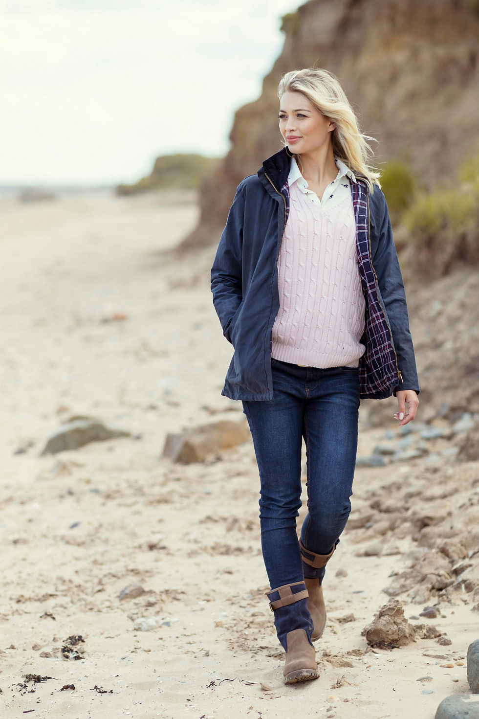 Woman taking relaxing autumn walk on beach