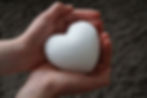 two hands holding a white puffy heart