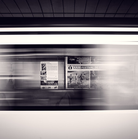 Subway advertisement moving by quickly in black and white by Mario Calvo