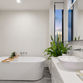 Modern freestanding bathtub in a minimalist bathroom setting, illustrating style considerations when choosing a bathtub