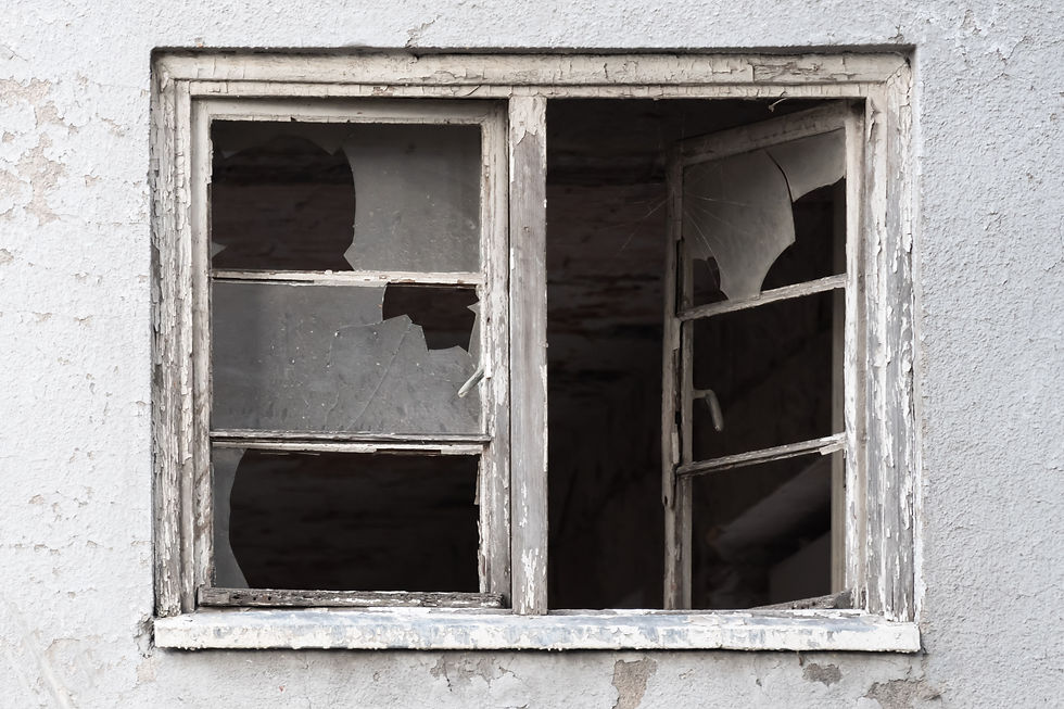 Weathered and broken, an abandoned window silently tells the story of time's passage.