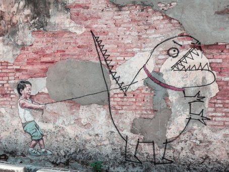 drawing on a wall of a boy catching a dinosaur