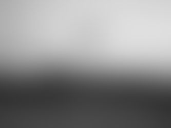 Drone hovers in the foreground with a city skyline in the background, set against a clear sky. Monochrome tones evoke a calm mood.