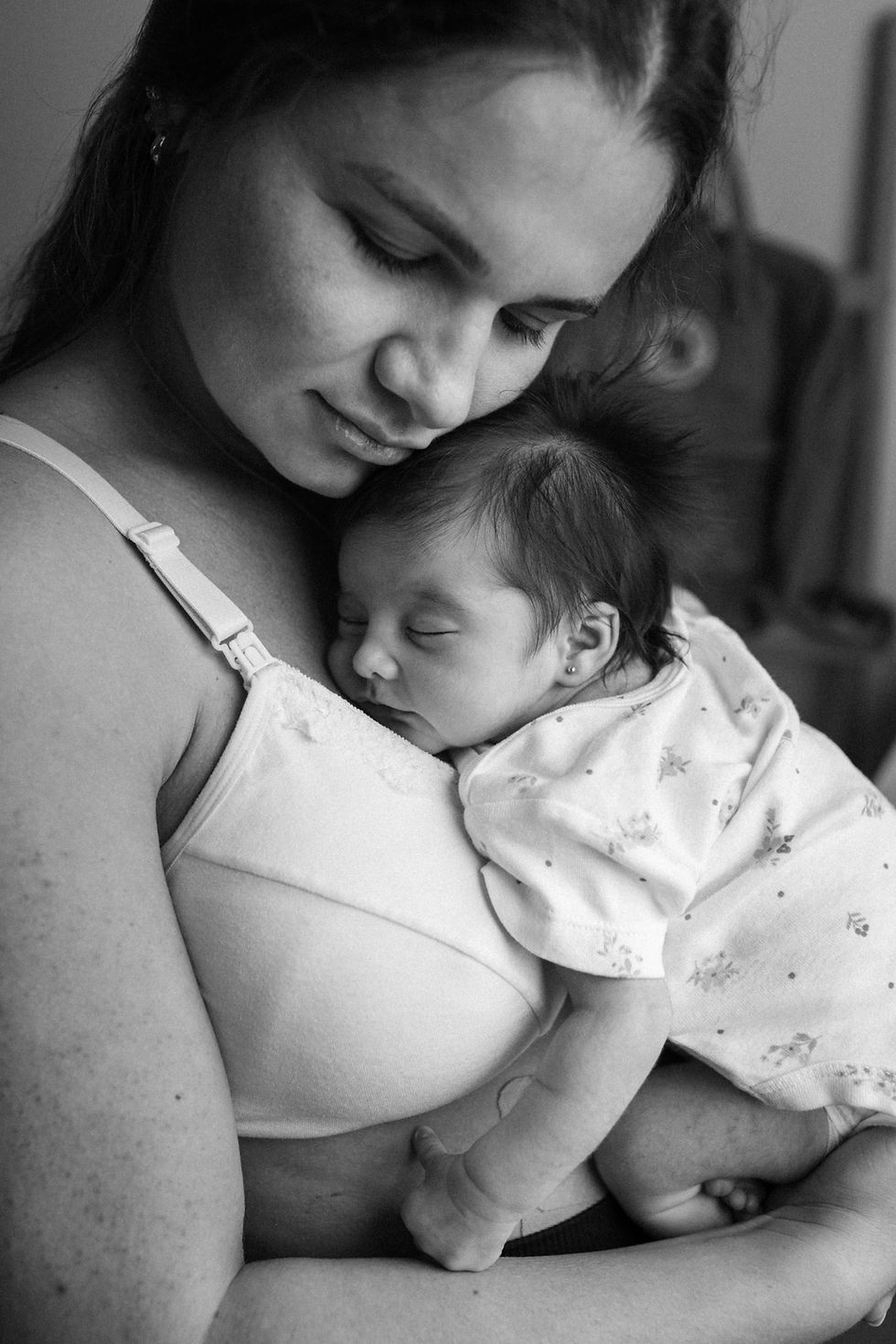 postpartum woman holding newborn seeking vaginal rejuvenation
