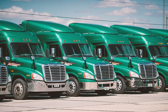 Several semi trucks parked in a line.