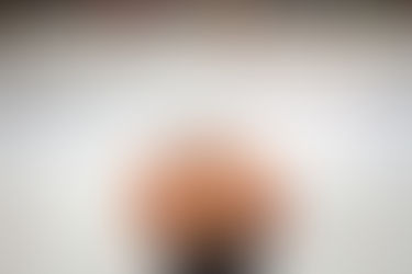 A minor hockey goalie watching the play in the other team's zone.