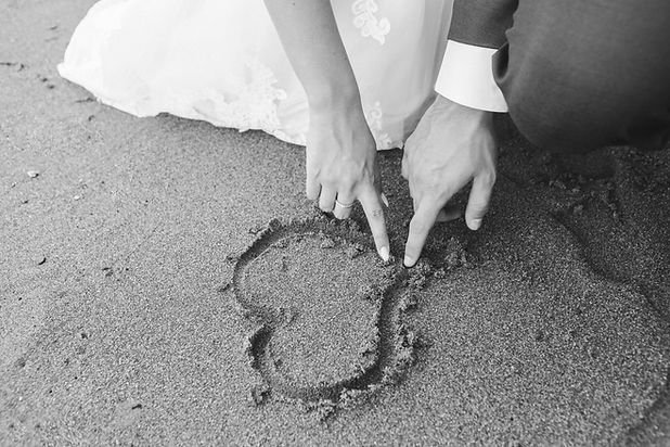 heart in sand made by couple