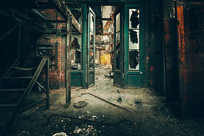 An abandoned building with windows broken out