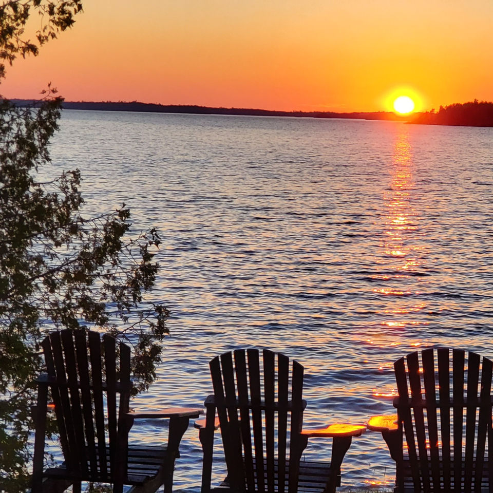 lake sunset with lounge chairs to watch the view