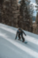 Snowboarder putting their hand down to prevent falling