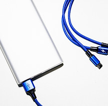 A portable power bank charging through a braided USB-C cable
