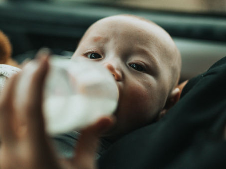 baby being fed with a bottle