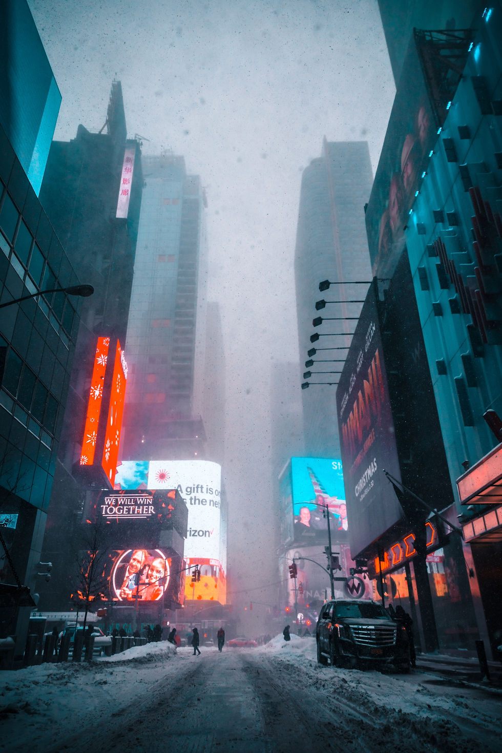 Snowy city street with people walking, surrounded by tall buildings and bright billboards. Prominent text: "WE WILL WIN TOGETHER."