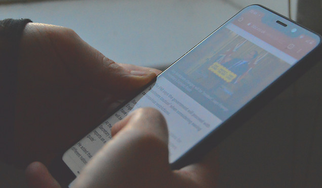 person scrolling through phone | miGenie The Ultimate Success System