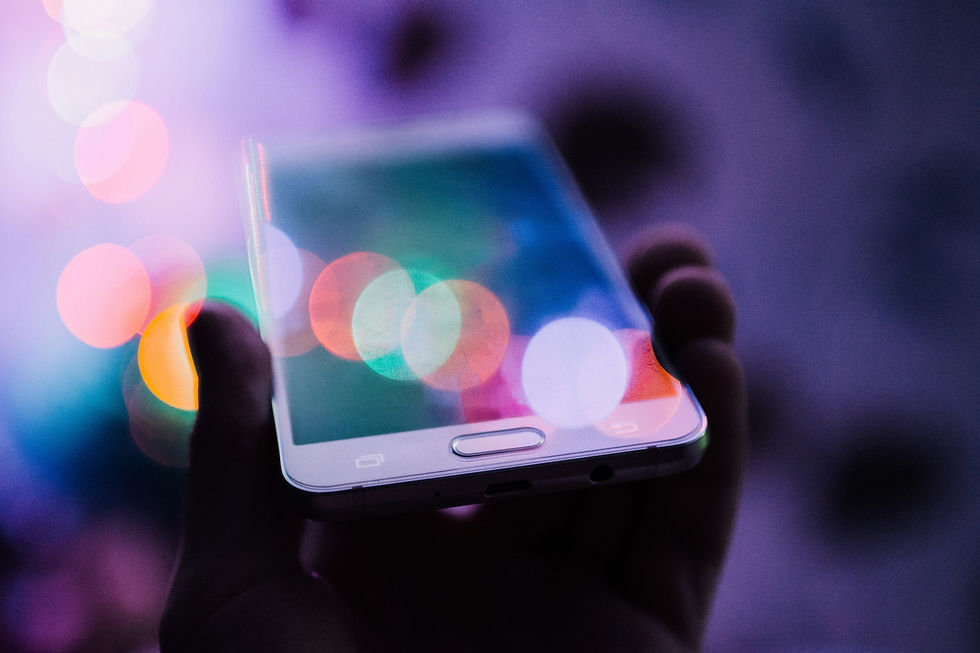 Hand holding a smartphone with colorful reflections