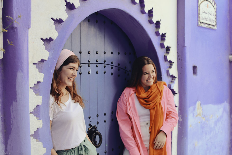 two female tourists smiling and having fun in morocco infront of a beautifull door