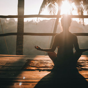 Woman meditating in tropical setting