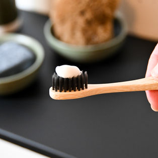 toothpaste on a bamboo toothbrush