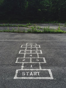A hopscotch game painted on a park path, representing playful learning and physical activity promoted by Elmhurst Education.