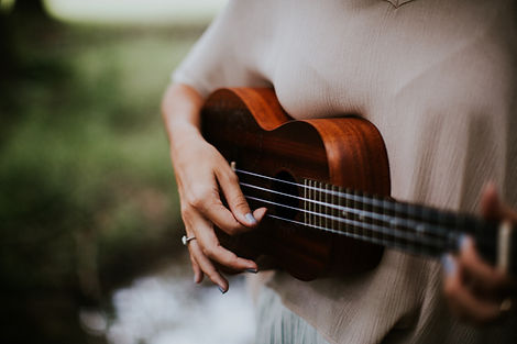 Image of a woman's hand playing a Ukulele, by Hannah Busing
