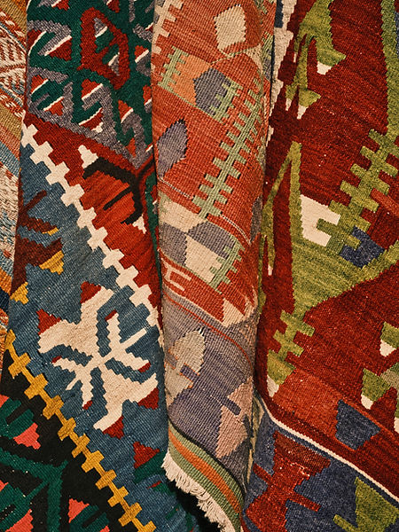 Rugs hung up on display