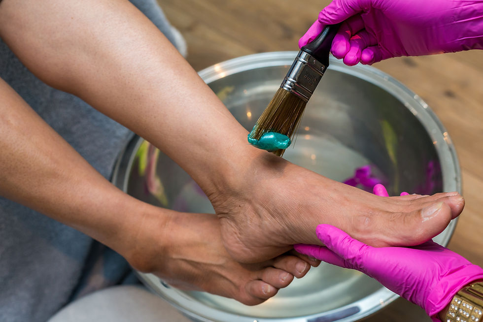 Podologin mit Handschuhen kümmert sich um Fuß und Zehen
