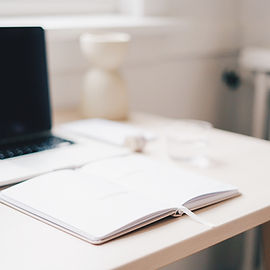 Notebook at a computer to show the set up of a virtual assistant in Canada