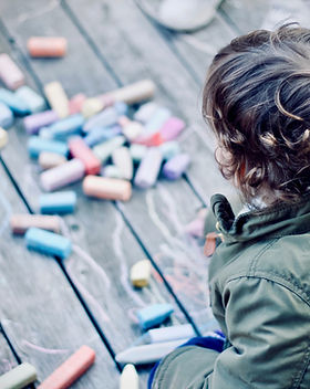 child drawing chalk
