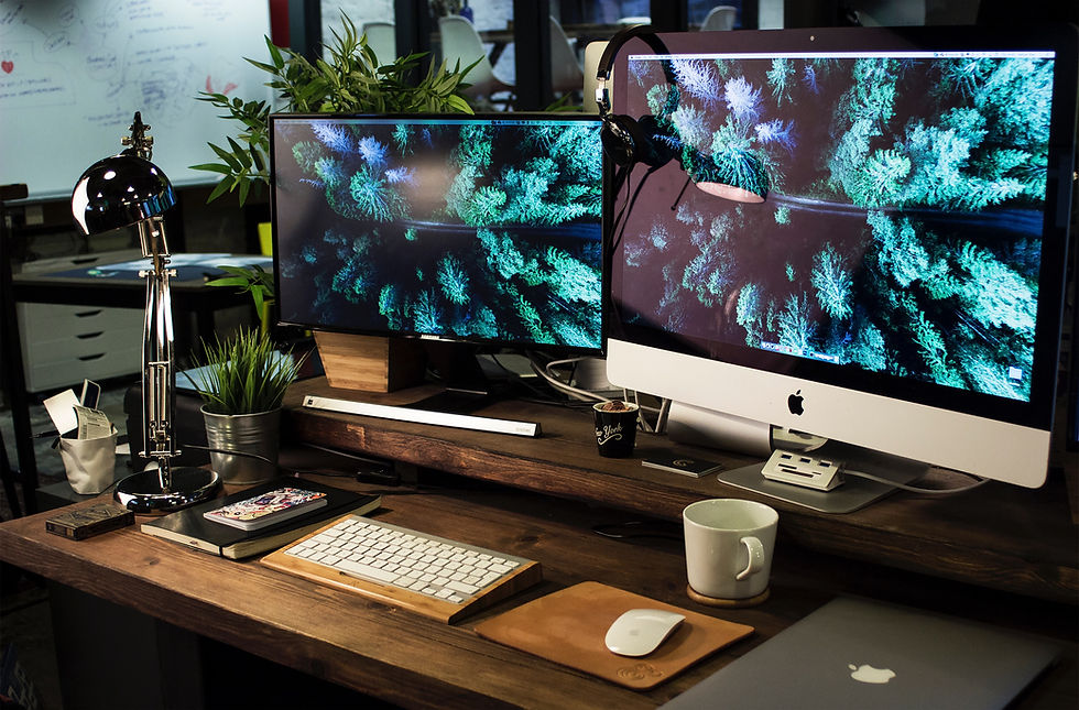 our graphic design workspace in Somerset: A desk with a computer and multiple monitors, showcasing a creative and professional setup for our design services.
