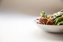 a beautiful, healthy salad in a white salad bowl