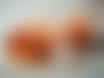 Cracked egg with a sad face spills yolk on a counter, while a blurred egg with a worried face sits behind it.