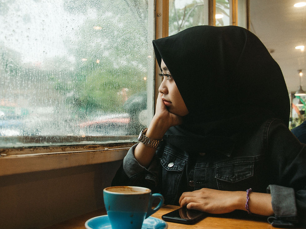 young girl looking off to the distance in a coffee shop