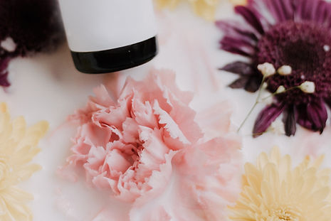 Flowers surrounding aroma therapy bottle